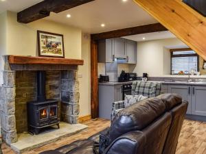 a living room with a couch and a fireplace at Little Jacks Cottage in Todmorden