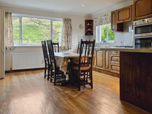 a kitchen with a table and chairs in a kitchen at Barr Beithe Upper in Dalavich