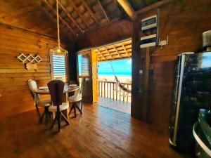 a dining room with a table and a view of the ocean at Chalet Paraiso Canoa na praia - Canoa Quebrada in Canoa Quebrada