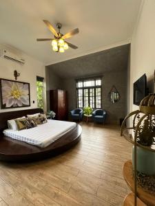 duża sypialnia z łóżkiem i wentylatorem sufitowym w obiekcie HELLO VILLA & SPA w mieście Hue