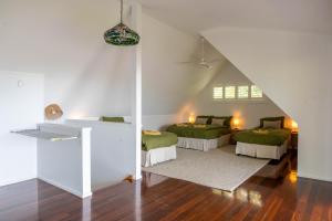 a attic room with two beds and a staircase at Serenity - Gold Coast hinterland getaway for a couple, family or group in Mount Tamborine
