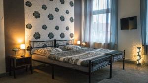 ein Schlafzimmer mit einem Bett und einer Wand mit Blumen in der Unterkunft Ferienwohnung zum alten Hotel in Gramzow