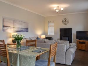 a living room with a table and a couch at Chapel Farm in Stelling