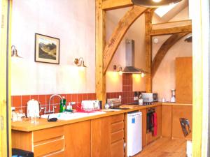 a kitchen with wooden cabinets and a counter top at Bayfield Plus in Foulsham