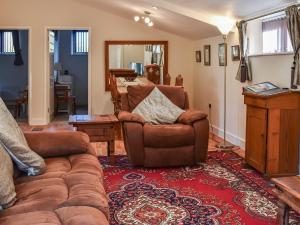 a living room with a couch and a chair at Fig Tree Barn in Worth