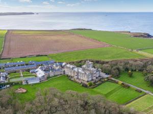 an aerial view of a castle with the ocean in the background at Cranford Cottage in Saint Brides