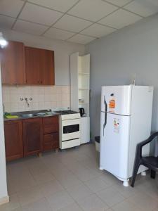 a kitchen with a white refrigerator and a stove at Depto monoambiente temporario in Resistencia