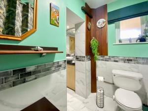 a bathroom with a toilet and a sink at Fieldview Snug in Penselwood