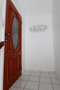 a wooden door with a sign that reads welcome at C&D Residential Penthouse in The Valley