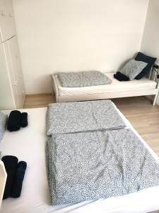 two beds in a small room with two beds at CORSO Central Home, Keszthely in Keszthely