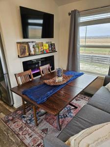 a living room with a wooden table and a couch at Buffalo Jump Guest House in Three Forks