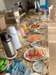 a buffet with plates of food on a counter at VILLA DEL SOL Hotel in Fortaleza