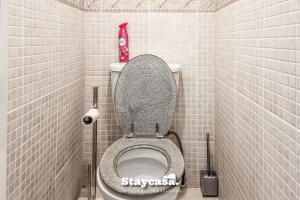 a small bathroom with a toilet in a stall at Tranquil Annex With Hidden In Beautiful Setting in Bredbury