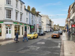 a busy city street with cars and people crossing the street at Marina View in Whitehaven