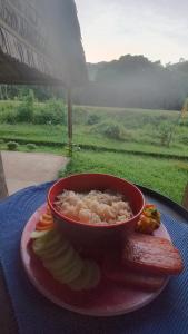 a bowl of rice on a plate on a table at Tony's Country Glamping with chalet with private wash room accommodation in El Nido