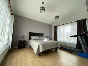 a bedroom with a bed and a large window at Casa Patagonia in Puerto Natales