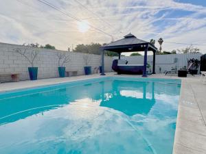 a swimming pool with a gazebo and blue water at Disneyland Retreat-Pool Spa Game in Anaheim