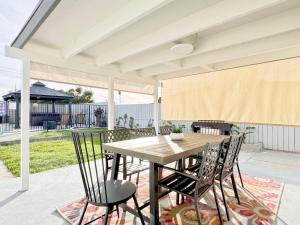 a dining room with a table and chairs on a patio at Disneyland Retreat-Pool Spa Game in Anaheim