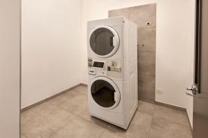 a washer and dryer sitting in a room at City Express Junior by Marriott Leon Centro de Convenciones in León
