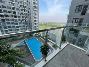 a balcony with a swimming pool in a building at An apartment, city view with pool gym free, 5min from city in Thôn Văn Dương