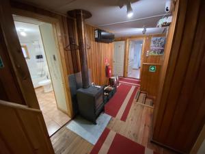 a living room with a wood burning stove in it at Hostería Futaleufu in Futaleufú
