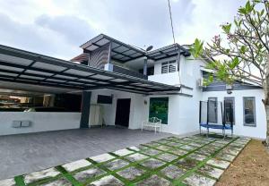 a white house with a large patio in front of it at Modern Cozy House 4Room10pax @Near Sunway Carnival in Perai
