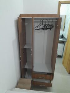 a closet with a glass door in a room at Studio fantástico in São Paulo