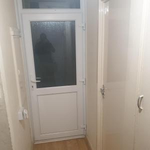 a white door with a window in a room at Bakus Executive Suite in Abbey Wood