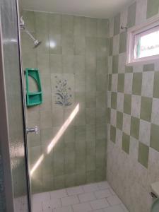 a shower with a glass door in a bathroom at Hospedaje Casa Pachi en Cartagena de Indias in Cartagena de Indias