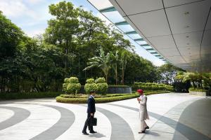 two people standing in front of a garden at The Westin Mumbai Garden City in Mumbai