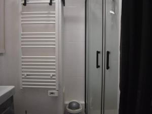 a glass shower door in a bathroom with a toilet at Studio Font-Romeu-Odeillo-Via, 1 pièce, 2 personnes - FR-1-580-102 in Font-Romeu-Odeillo-Via