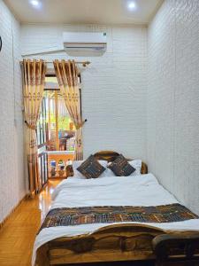 מיטה או מיטות בחדר ב-Mai Anh Homestay - Pac Bo Village