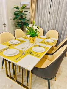 a dining room table with plates and glasses on it at Krabi Aonang & Alpha villa in Ao Nam Mao