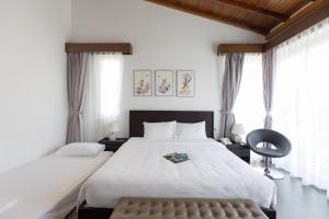 Giường trong phòng chung tại Xanh Villas Resort & Spa - by Bay Luxury