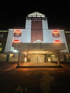 a large building with a clock tower at night at ホテルチャハヤ稲敷佐原東 in Itako +21 photos