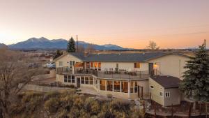 an aerial view of a house with mountains in the background at Great Salida Getaway - 20 minutes to Monarch with Spa & Gameroom in Salida