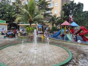 a water park with a fountain and slides at Syariah Hotel Sentul in Bogor