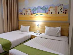 Voodi või voodid majutusasutuse Lorin Syariah Hotel Sentul toas