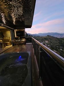 a bathroom with a bath tub on a balcony at La casa en el aire in Medellín