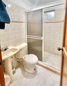 a bathroom with a shower and a toilet and a sink at Charming villa near to Medellín Metro and malls in Copacabana