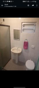 a bathroom with a sink and a toilet at Suítes econômica 250 metros do mar in Piçarras