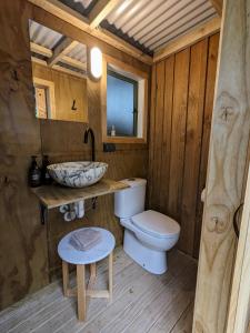 a bathroom with a toilet and a sink at Piccola Casa Fiorita in Mount Maunganui