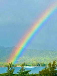 a rainbow over a lake with mountains in the background at BBs Biz E HBR 4104/5/6 in Princeville