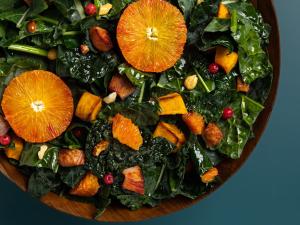 a bowl filled with a salad with oranges and greens at HOTEL THE FLAG Shinsaibashi in Osaka