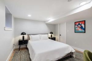 1 dormitorio con 1 cama blanca grande y 1 silla en Downtown Denver Gem en Denver