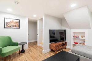 a living room with a flat screen tv and a couch at Downtown Denver Gem in Denver