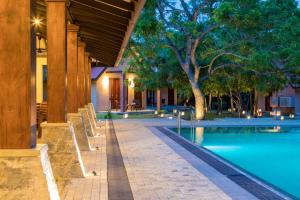 a resort with a swimming pool and a building at Yala Chalets by Lalan Leisure in Kirinda