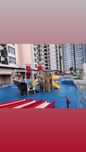 a swimming pool with a playground in a city at SuteraMuslimHomestay Bali Residence Melaka in Melaka