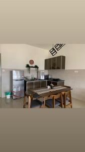 a kitchen with a table and a kitchen with a refrigerator at SuteraMuslimHomestay Bali Residence Melaka in Melaka