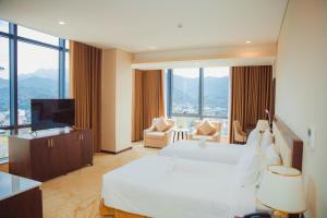 a hotel room with a bed and a flat screen tv at Muong Thanh Luxury Cao Bang in Cao Bằng